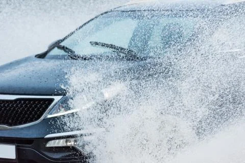 Car rain puddle splashing water Fotos Stock