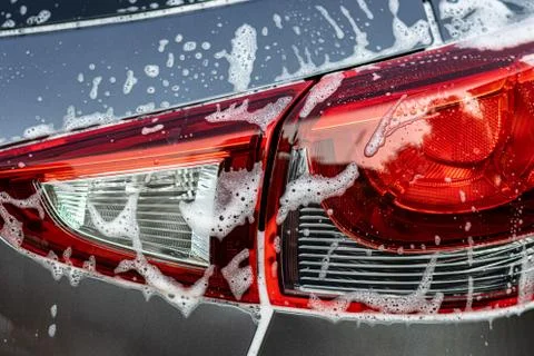 Car rear light with flow down white foam. Stock Photos