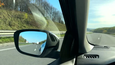 Car rear mirror reflection of the highway Stock Footage 256153338