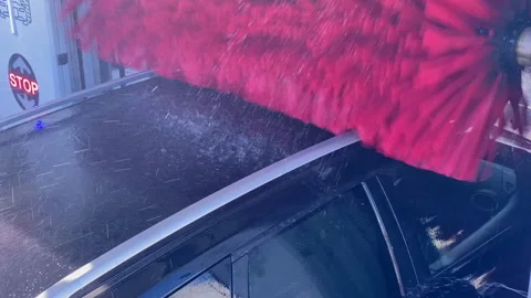 Car receiving automatic cleaning service in car wash Stock Footage 333038439