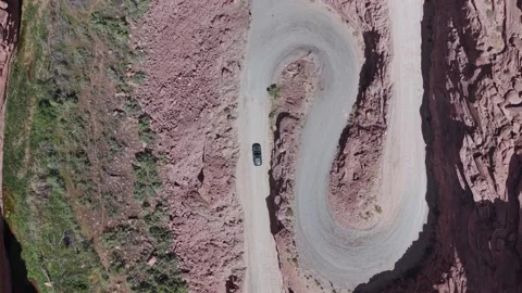 Car on Red Rock Switchback Road in Moab Utah Rise Stock Footage 333404673