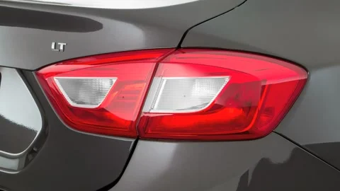 Car red tail light close up Tungsten Metallic 2017 Chevrolet Cruze LT Automatic Stock Footage 159913062