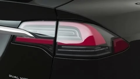 Car red tail light close up Solid Black 2019 Tesla Model X Long Range Stock Footage 160082403