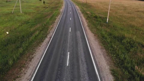 Car with reflected blue sky in windshield drives along road Stock Footage 135251502