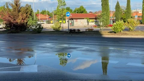 Car reflected in puddle after rainfall on urban street Stock-Footage 336733777