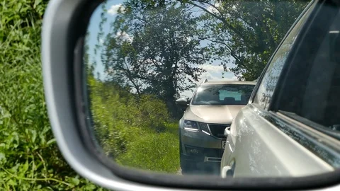 Car reflection in door rear view mirror Stock Footage 94528247