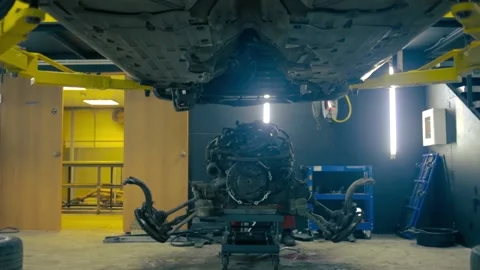 Car with removed engine in service Stock Footage 131299412