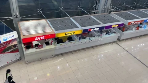 Car rental service counters top view at airport. Woman airport staff walking Stock Footage 183530128