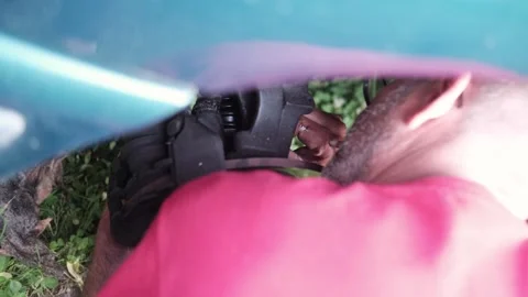 Car repair. Close-up of a man's hands with a screwdriver repairing a car disk Stock Footage 249792159