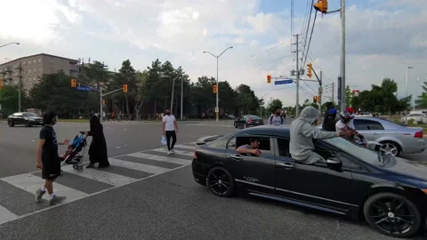 Car revving engine loudly while rider is sitting on window frame in careless Stock Footage 136854351