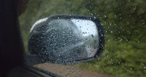 Car ride mirror view while raining  Stock Footage 114863976