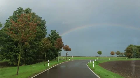 Car ride in the rain with rainbow. Stock Footage 218533095