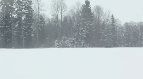 Car ride by road near forest at winter day, show from train Stock Footage