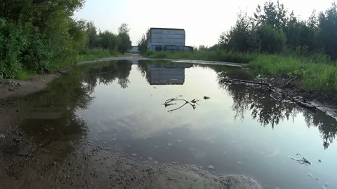 The car rides on bumpy road through a huge puddle. View from the car Video stock 71814014