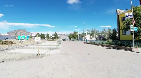 Car Rides Down the Empty Street of West Mongolian City With Several Adjoining Stock Footage 60577935