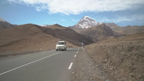 Car rides on the empty road in mountains Video stock 231250307