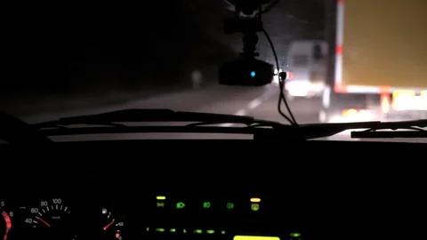 Car rides on the night road. Inside view. Dashboard, radio, DVR. Overtaking. Stock Footage 100844038