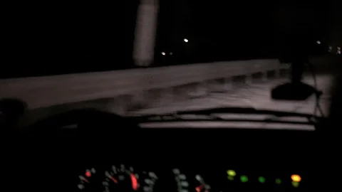 Car rides at night on a very bad road. The car cracks and staggers. Inside view. Stock Footage 100843677