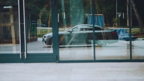 The car rides in the reflection of the glass windows. Shooting from a car Stock Footage 158559924