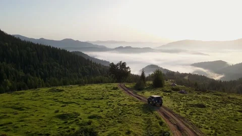 The car rides on the rod between the mountains Stock Footage 176553058