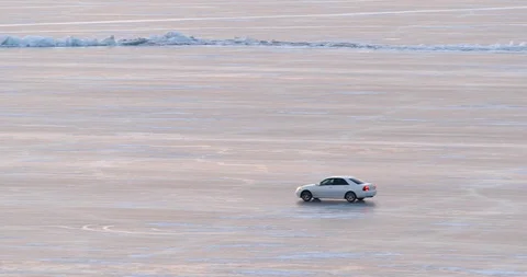 Car Rides On The Surface Of The Ice-covered Lake Stock-Footage 104198248