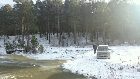 Car rides on a winter forest road on a sunny day Stock Footage 119908415