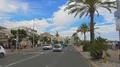 Car riding in resort city street, people walking on embankment, urban life 4k or 4k+ Resolution
