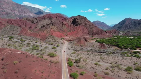 Car riding through eroded mountain landscape of Quebrada Las Conchas in Salta Stock Footage 293211163