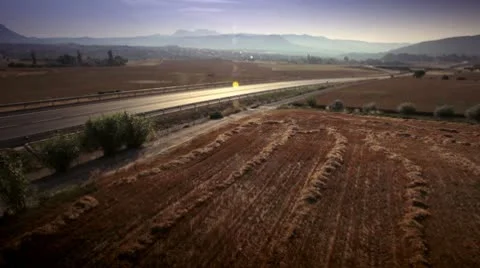 Car on a road between fields Stock Footage 9026147