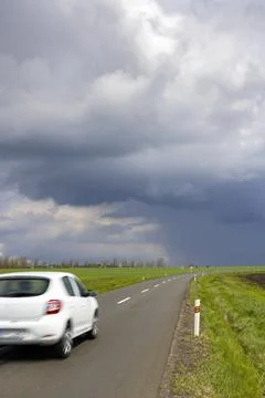 A car on the road with dramatic sky Stock Photos