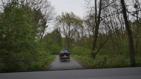 Car on a road in the forest in spring Stock Footage 75065527