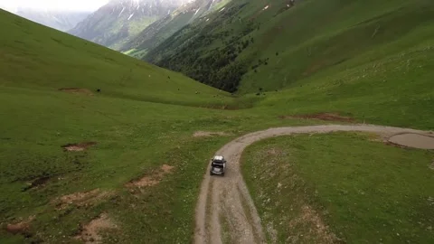 Car on road in green mountains Stock Footage 314908342