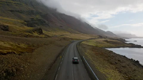 Car On A Road With A Mountainside View Covered With Clouds Video stock 231255403