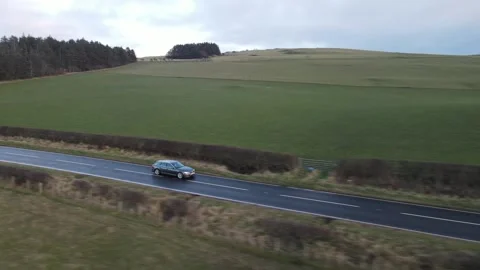 Car on road passing cemetery Stock Footage 336997998