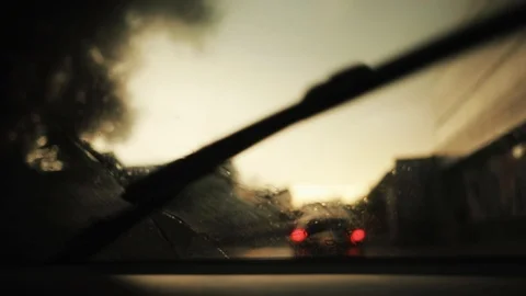 Car on the road rain flows and wipers on the front windshield glass window of Stock Footage 94531412