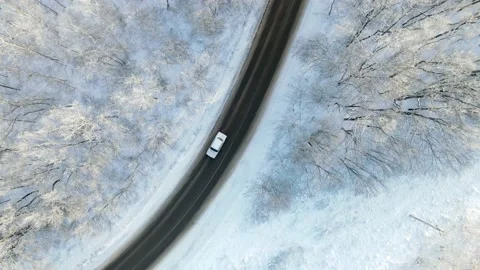 Car on the road surrounded by winter forest. Aerial top view Stock Footage 223551407