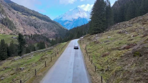 A car on the road through the Alps Stock Footage 238478465