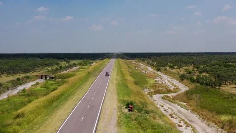Car on road trip crossing an empty straight asphalt road Stock Footage 264095440