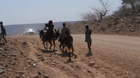 Car running in namibia streets, dry landscape, Africa 4K, People riding donkeys Stock Footage 90912248