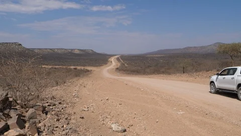 Car running in namibia streets, wild dry landscape, Africa 4K desert, blue sky Stock Footage 90910665