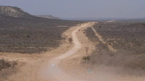 Car running in namibia streets, wild dry landscape, Africa 4K desert, blue sky Stock Footage 90912202