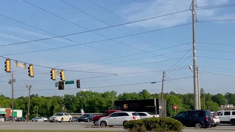 Car running a red light 4 way intersection on a busy highway Stock-Footage 153612416