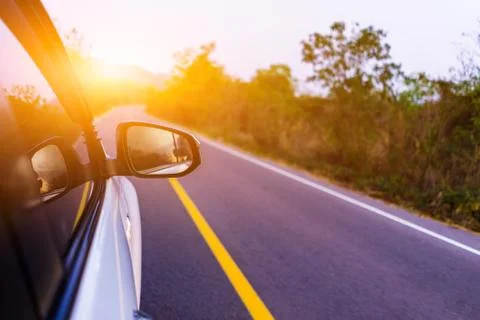 Car is running on the road, looking from inside the car in the morning. Stock Photos