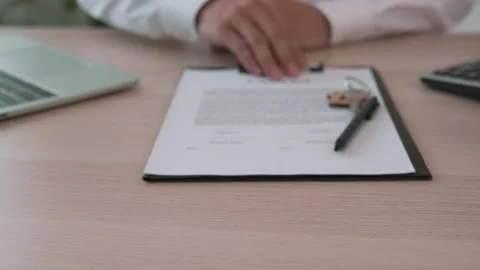 Car sales representative submits the contract documents for the customer to sign 스톡 동영상 164158687