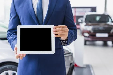 Car salesman with tablet Fotos de archivo