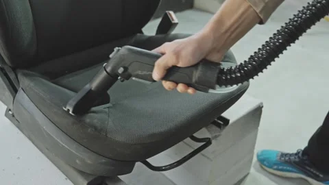 Car seat cleaning process in bright workshop with detailer working hard Video stock 319442252