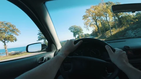 Car seen from drivers perspective with hands on the steering wheel Stock Footage 98073555