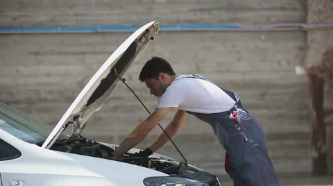 Car service: mechanic looks for errors in the car, car repairs, warranty Stock Footage 53465366