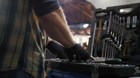 Car service. Mechanic man looking for a tool in the case Stock Footage 101687664