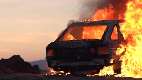 Car set ablaze at sunset Video stock 73022769